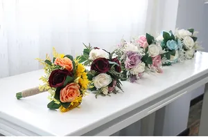 Detail of five artificial bridal bouquets with rustic twine handles for wedding decor