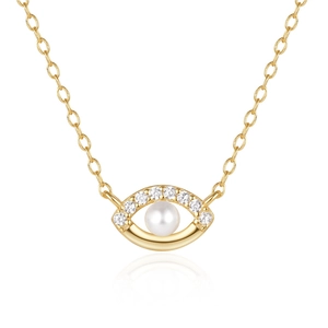 Macro shot of 925 silver golden eye pendant with pearl and sparkling pavé crystals