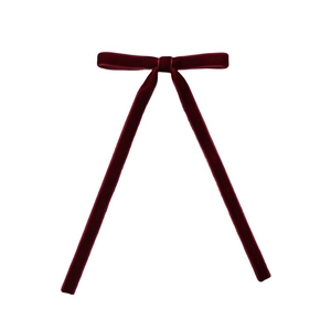 Detail of burgundy velvet hair clip with elegant long ribbons for bridesmaid hairstyles