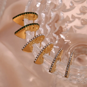 Detailed set of golden geometric earrings with green stones, pearls, and zircons