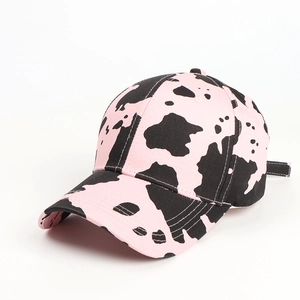 Detail of pink cow print baseball cap featuring high-quality cotton twill texture