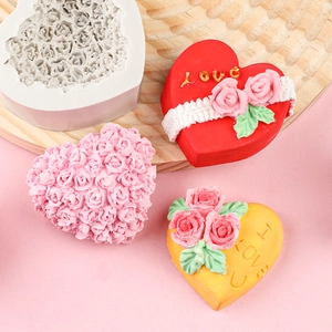 Detailed view of heart-shaped rose silicone mold with finished floral fondant cakes