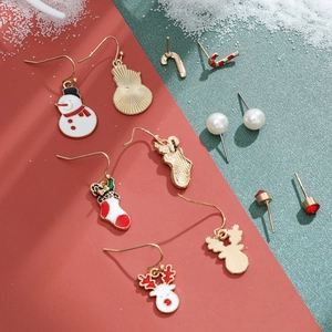 Detailed close-up of Christmas stud earrings featuring snowman and reindeer designs