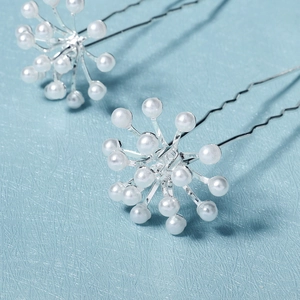 Elegant pair of silver bridal hair pins with white pearls for wedding hairstyling