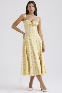 Detailed macro view of the yellow floral summer dress showing fabric texture and print