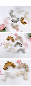 Detail of wavy acetate hair claws in tortoise and marble colors with elegant textures