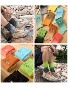 Detail of gradient knit socks with AURORA embroidery in multiple colors and textures