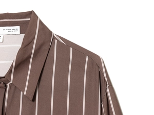 Detail of a brown striped shirt showing fabric texture, neckline, and sizing label