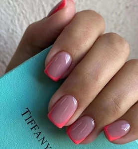 Macro view of French square press-on nails in nude pink and coral red tips