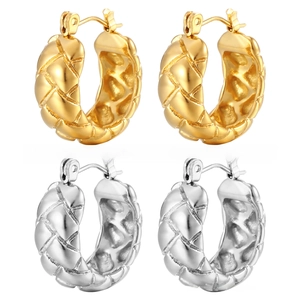 Detail view of gold and silver textured hoop earrings with quilted lattice pattern