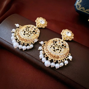 Detailed shot of vintage gold earrings with rhinestones, crystals and pearls