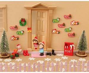 Miniature dollhouse Christmas scene set with tiny trees, red post box, and festive decor
