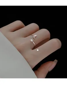 Macro shot of silver adjustable index ring with sparkling zircon details on hand