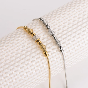 Elegant gold and silver snake chain bracelets with sparkling diamond spacers and metal beads