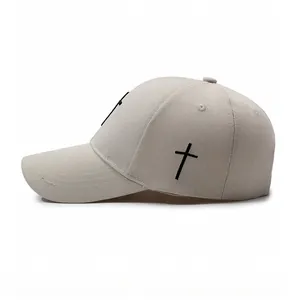 Detail of cross embroidery on the side of a beige cotton canvas baseball cap