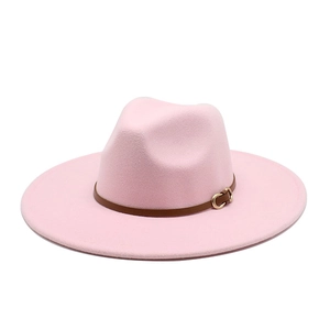 Detail of pink fedora hat featuring a brown leather band and gold metal buckle