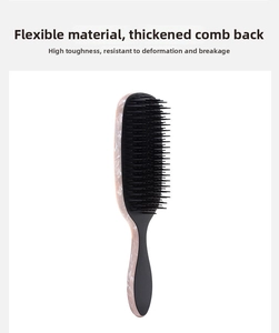 Detail of marble pattern hairbrush showing flexible material and thick durable back