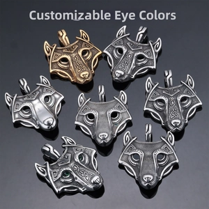 Detailed close-up of viking wolf head pendants in gold, silver and vintage finishes