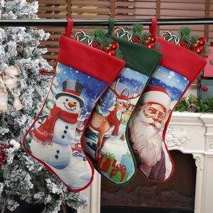 Three Christmas stockings with Santa, reindeer and snowman hanging on a fireplace