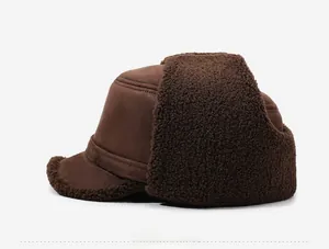 Detail of dark brown suede winter hat with thick sherpa fleece lining and metal side logo