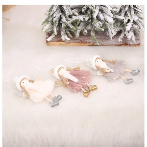 Three plush angel doll ornaments in white, pink, and grey on white faux fur carpet background