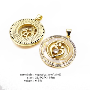 Detailed macro view of heart MOM pendants with gold plating and cubic zirconia inlay