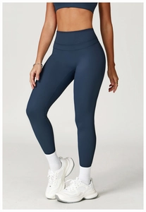 Close-up of high-waisted navy blue yoga pants featuring tummy control and matte stretch fabric