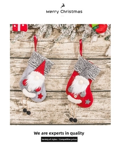 Close-up of knit Christmas stockings with forest gnome gnomes on rustic wood wall