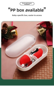 Close-up of stainless steel toddler cutlery with red silicone handles and storage case