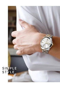 Detailed view of bicolor stainless steel watch strap and dual calendar display on wrist
