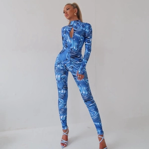 Detail of blue textured long sleeve jumpsuit with chest cutout and bodycon fit