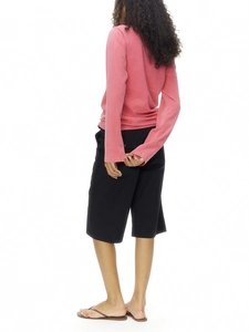 Pink crewneck long sleeve cotton t-shirt with black shorts shown from a back view