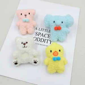 Detail of cute plush animal brooches with colorful bows for creative DIY decoration