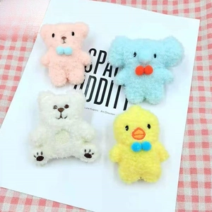 Detail of cute plush animal brooches with colorful bows for creative DIY decoration