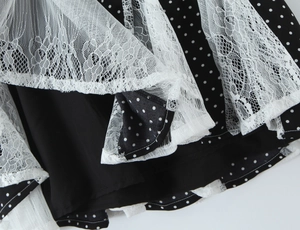 Detail of polka dot fabric and white lace trim on the pleated halter dress hem