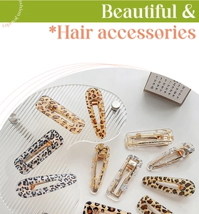 Detail of leopard print and gold foil acrylic hair clips set in teardrop and square shapes