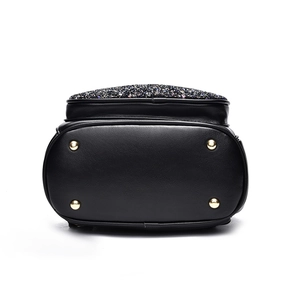Cute black glitter backpack with golden metal feet and sequin flap detail on white background