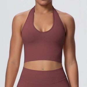 Close-up of halter neck sports bra with deep V-neckline and ribbed texture in dusty rose