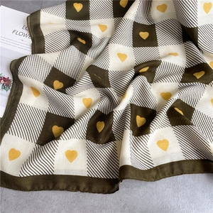 Close-up of checkerboard and heart patterns on cotton-linen feel scarf wrap