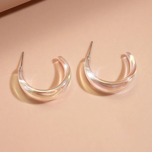 Detailed view of iridescent C-shaped acrylic hoop earrings with a futuristic clear finish