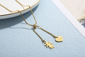 Detailed macro view of golden snake chain with adjustable slider and heart pendant