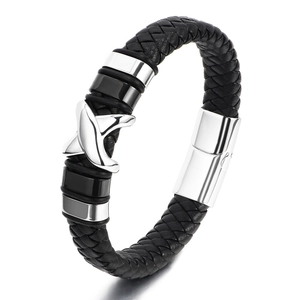 Detail of men's black braided leather bracelet featuring X-shaped magnetic clasp closure