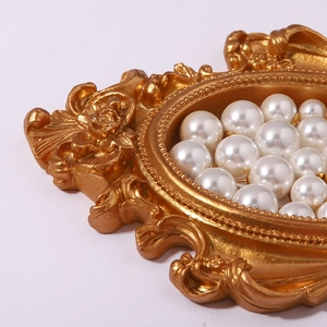 French vintage gold embossed tray with luxury white pearls for an elegant jewelry display