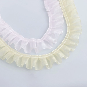 Detail of 2.5cm pleated organza lace ribbon in light pink and soft yellow for DIY crafts