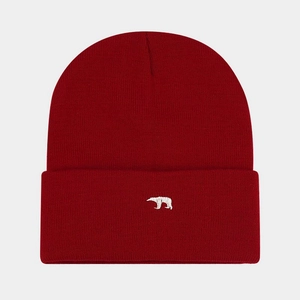 Close-up of white polar bear embroidery on dark red knitted beanie with warm texture