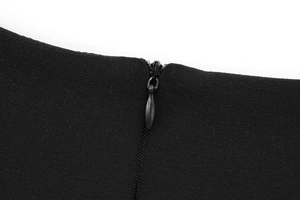 Close-up detail of invisible zipper on black dress with fine woven fabric texture