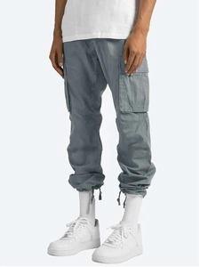 Detail view of cargo pants featuring side flap pockets and drawstring hem in slate blue