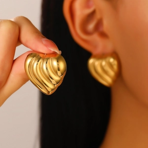 Detailed close-up of 18K gold plated heart earrings with textured 3D ribbed surface