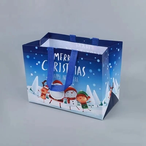 Detailed view of Merry Christmas non-woven gift bag with Santa and reindeer illustration
