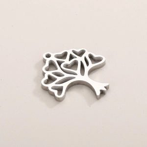 Macro detail of silver Tree of Life pendant featuring intricate heart-shaped cutouts